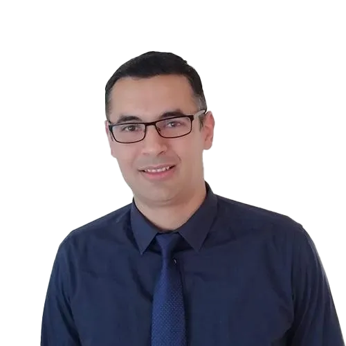 Yousef-Shanib-Transparent Person in glasses and tie smiling in a portrait.