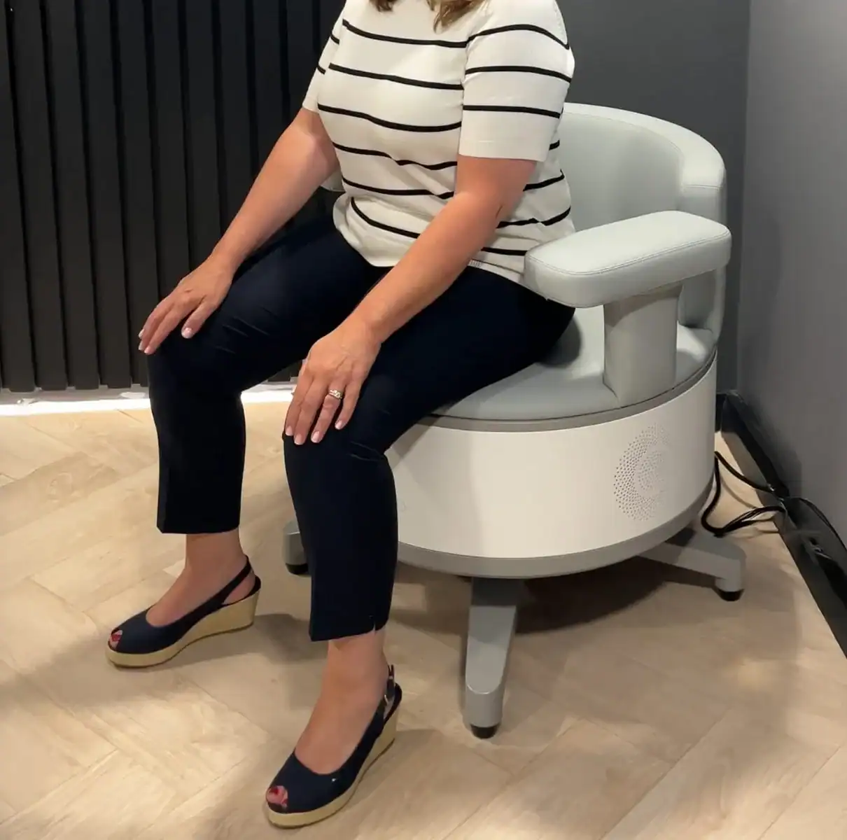 Woman sat on seat Person sitting on a modern therapeutic chair.
